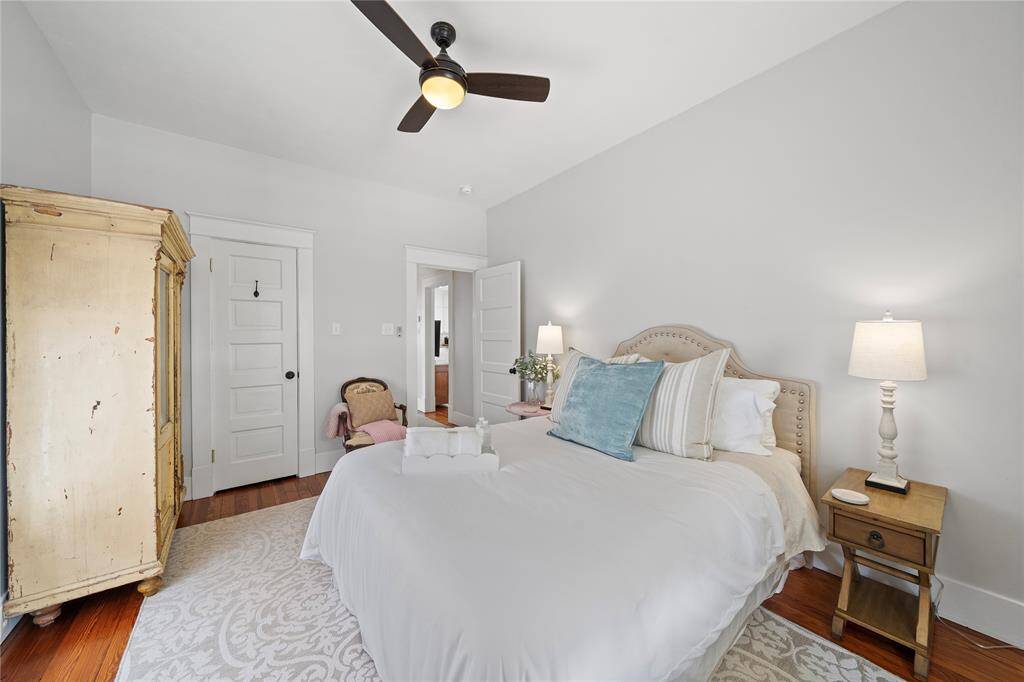 This bedroom has a queen bed, 2 night stands, dresser, armoire, and chair with lots of room to walk around.  This room could easily fit a king size bed.