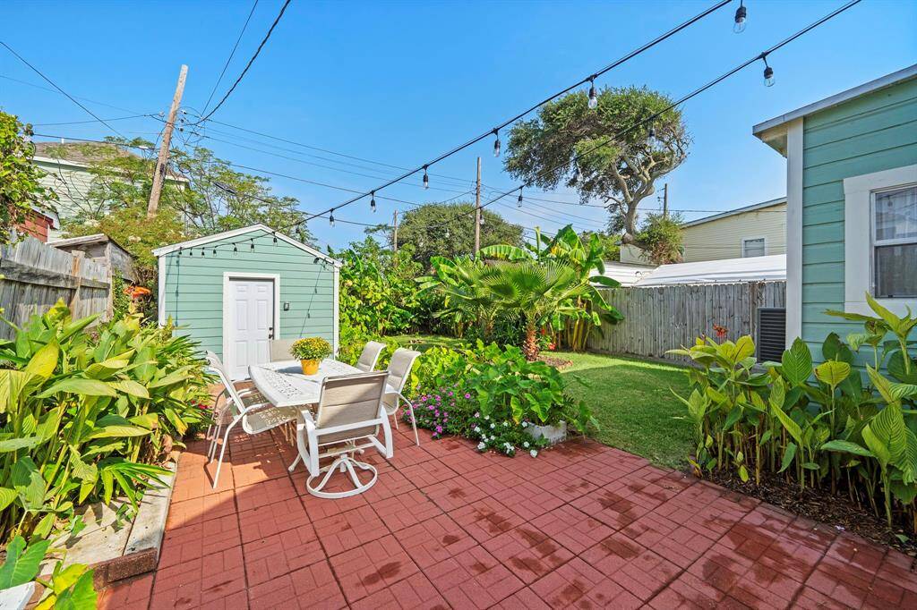 Beautiful lush landscaping, large patio, storage shed, outdoor shower with hot and cold water, and fully fenced.