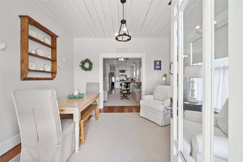 Step inside this restored 1920's cottage and relax in this front parlor that is currently set up as a dining and sitting area.  The ceiling has exposed ship lap adding to the charm!  All the millwork/moldings have lovingly been restored.