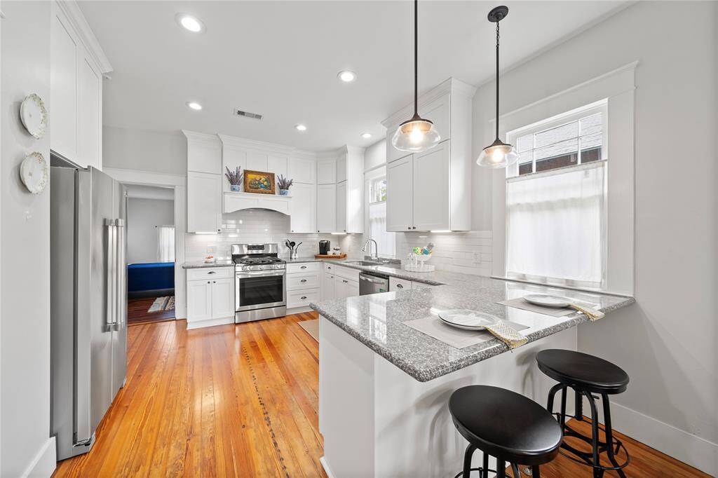 REMODELED KITCHEN with Custom Cabinets that give drama to the space and LOTS OF STORAGE!  Loads of counter space too!