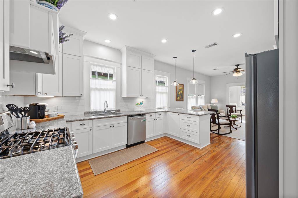 Tons of cabinets for storage with soft close drawers and doors.  Granite counters that compliment the designer paint colors.