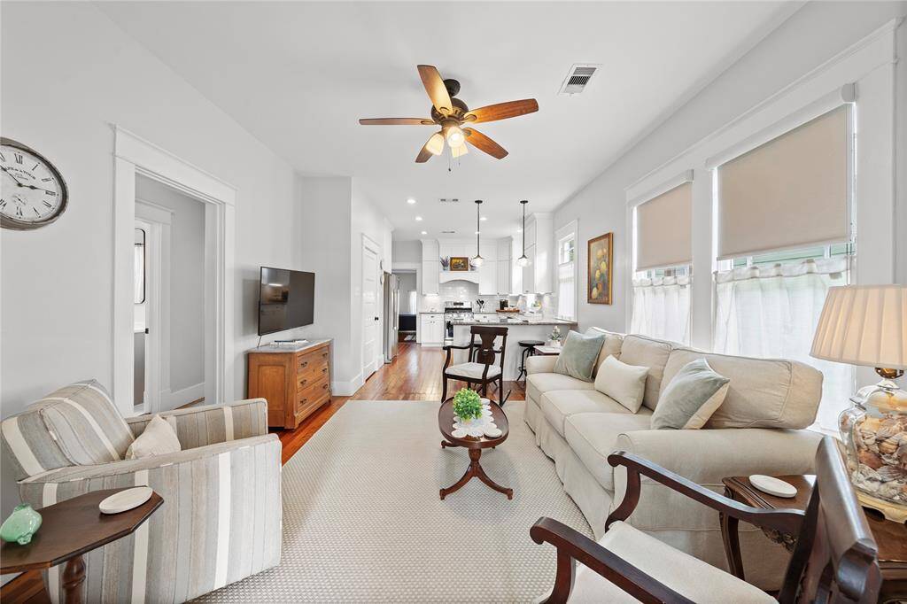 This next space is set up as the TV room and is large enough to accommodate six with its current layout.  It is open to the kitchen and the front parlor.