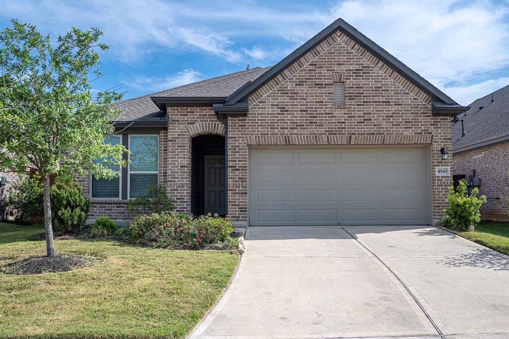 This charming single-story brick home features a two-car garage, a welcoming front porch, and well-maintained landscaping, offering great curb appeal in a quiet neighborhood.
