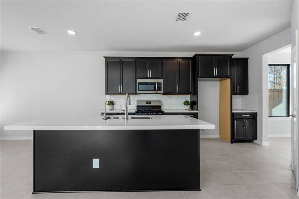 This kitchen awaits your arrival and decor!