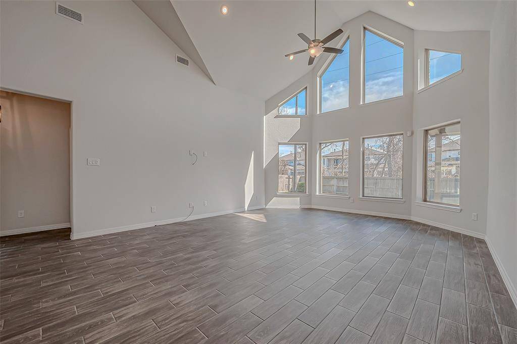 Stunning view of your Family Room offering high ceilings, architectural wall of windows bringing in an abundance of natural light