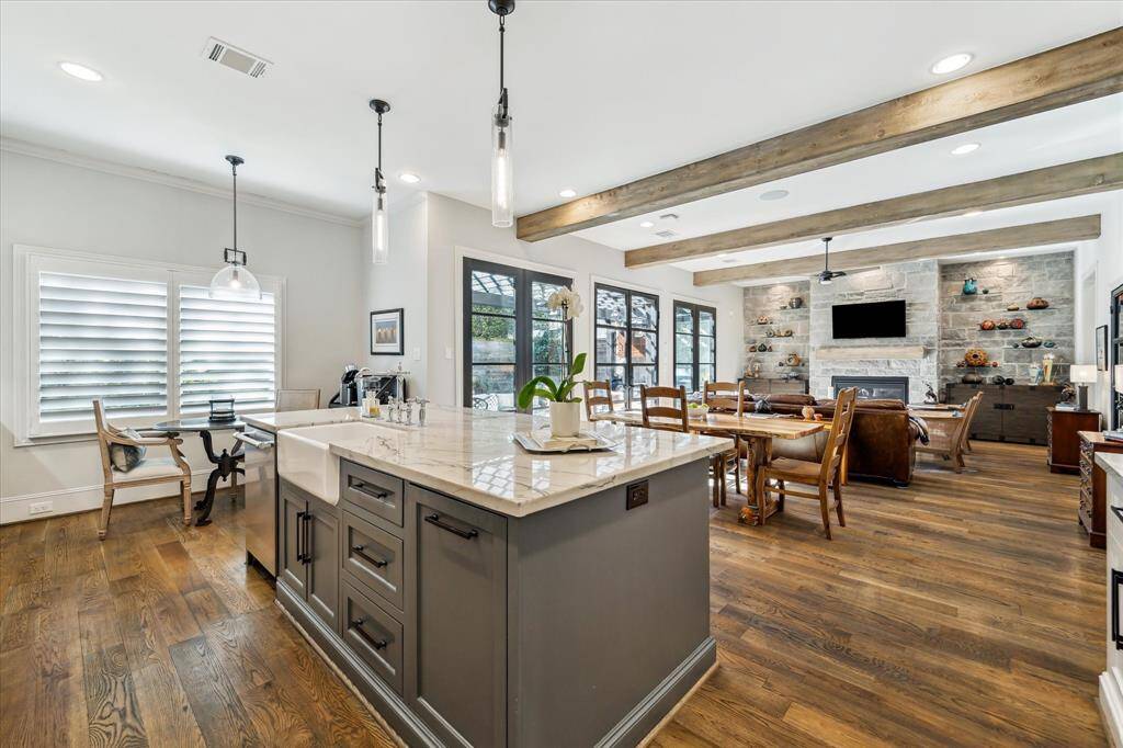 Who wouldn't love this gorgeous gourmet kitchen and island overlooking the great room/den! This beautiful island is topped with Giotto quartzite and offers ample space for bar stool seating. The floorplan offers great  views of the Den and outdoor entertaining area.