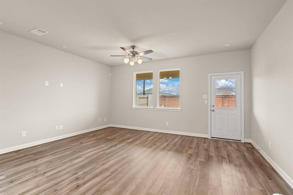 Your family room has ample space to entertain family and friends. This space features beautiful floors, fresh paint, ceiling fan with lighting, and high ceilings.