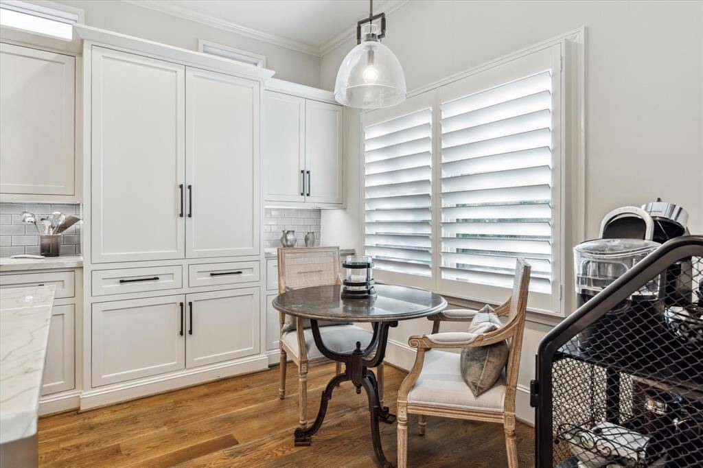 The sunny Breakfast area is located right off the Kitchen and in the background, you will see some of the custom cabinetry and storage which offers an abundance of pull-out drawers and and amazing space.
