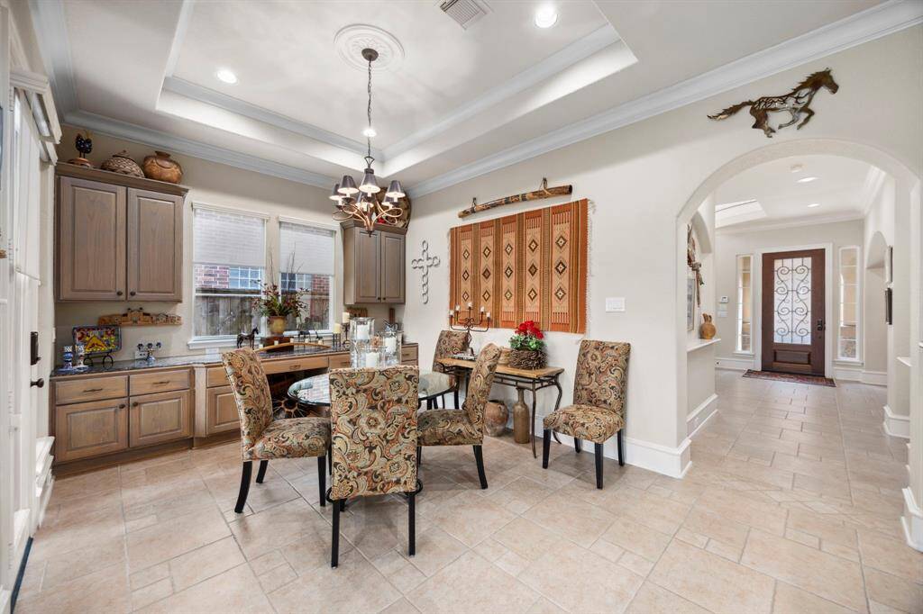 Further down the main hallway is the breakfast area also featuring built in storage and ample natural light.