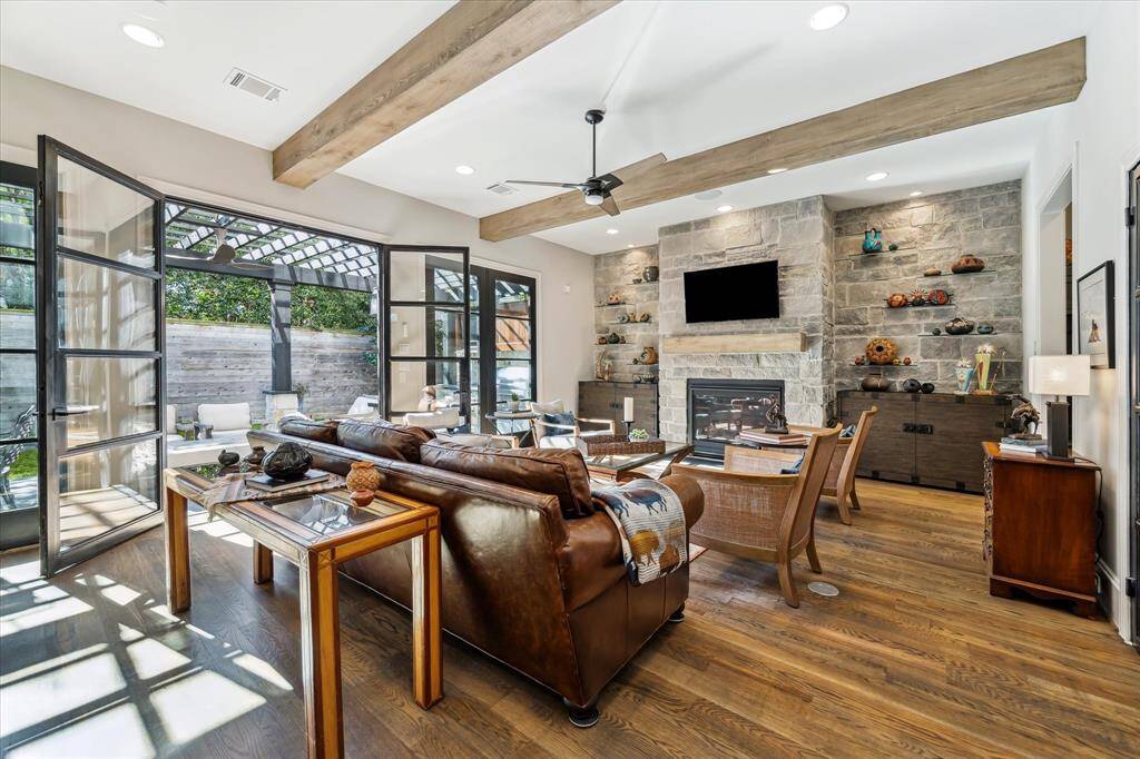 You will enjoy every minute in this gorgeous Great Room/Den with Flint River Limestone wall and fireplace, custom Wine Room and iron doors overlooking an expansive outdoor area.