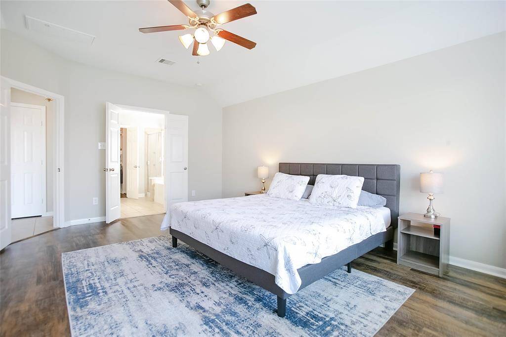 The primary bedroom is spacious, complete with a large walk-in closet.