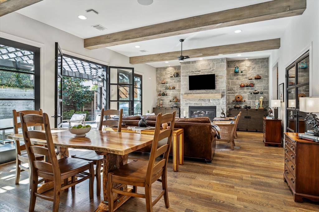 An alternate view of the Den. Some of the custom features are: Segreto-finished beams and fireplace mantel, speakers, limestone fireplace wall with floating glass shelves and more.