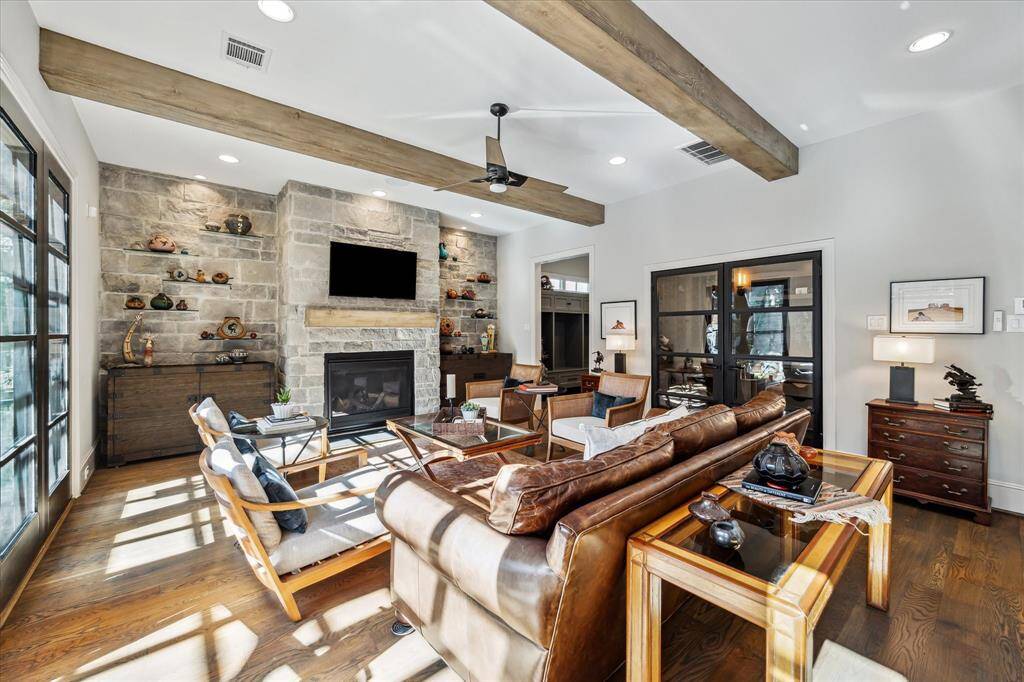 An alternate view of the Den. The Wine Room is seen on the right at the Iron double doors. The mud room is located to the right of the fireplace and at the garage entrance.