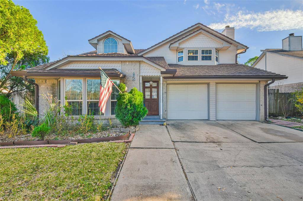 This inviting two-story home features a charming facade with a brick exterior, double garage, and well-maintained landscaping. The front yard includes a flag and offers a spacious driveway, while large windows provide ample natural light. Ideal for families seeking a welcoming neighborhood setting.