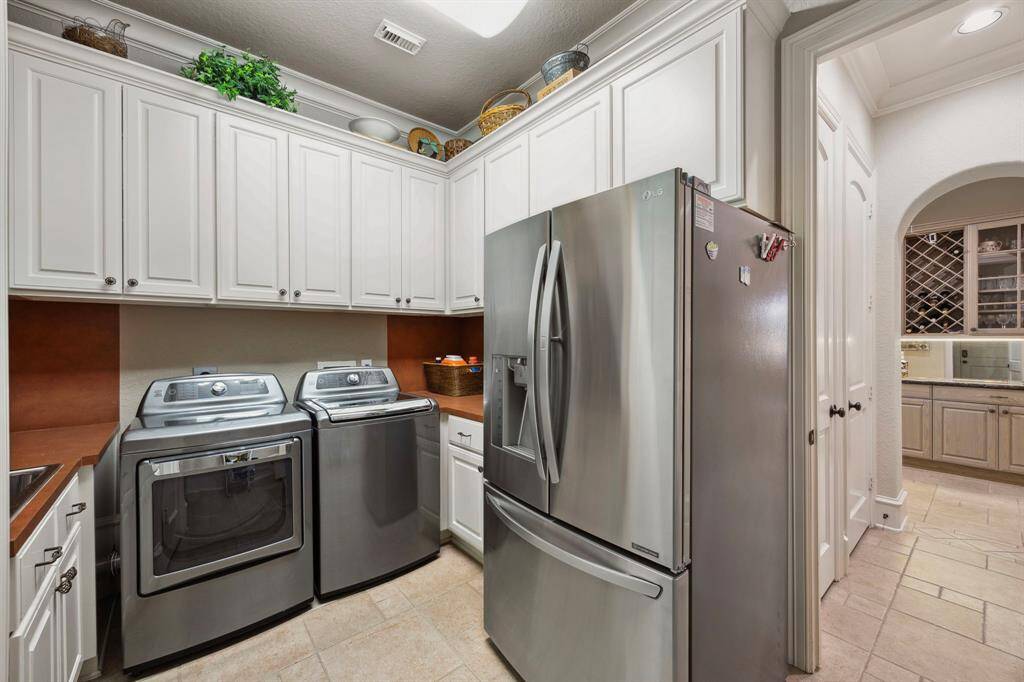 The generous utility room offers incredible storage space and serves an an entry from the 2 car attached garage.