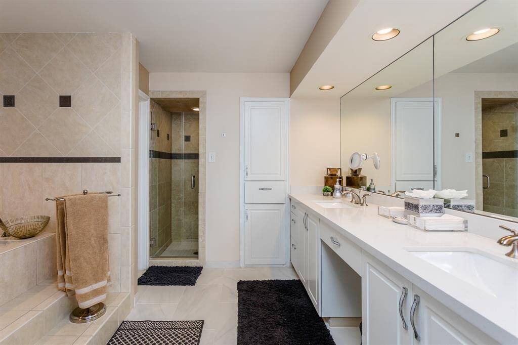 Primary bath with double sinks, tub and a walk in shower