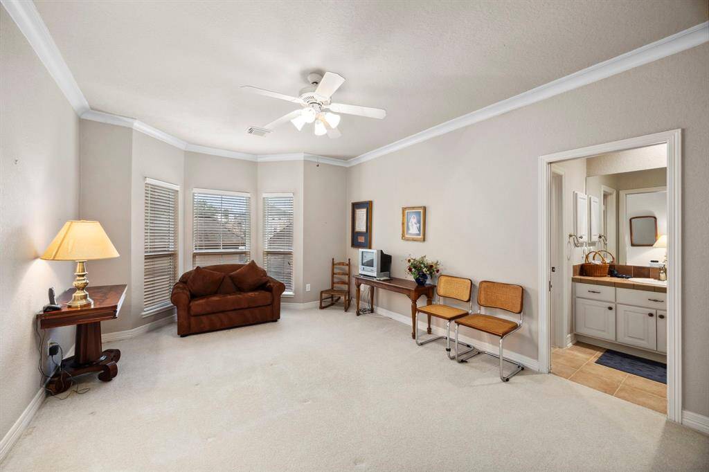 The first room off the hallway is this secondary bedroom overlooking the courtyard complete with its on ensuite bath. Each of the secondary bedrooms offer huge walk in closets.