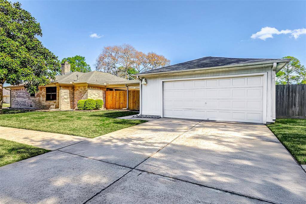 Even the garage is thoughtfully equipped with gutters for proper drainage, and an outdoor coach light illuminates the walkway leading to the side gate, enhancing both functionality and safety.
