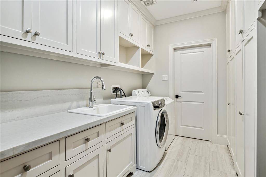 This Utility Room will make the laundry chore  fun! It is a wonderful size and so pretty with quartz countertops and a a custom wall of storage.  This room has a pocket door accessing the Primary closet and is located off the main 2nd floor hallway.
