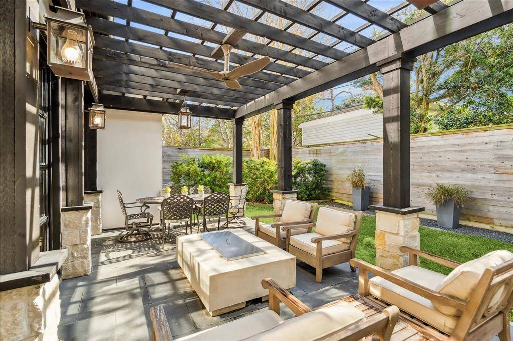 Step outside and start enjoying this outdoor living area. It is spendid with a wood pergola, Montauk Black slate pavers, Flint River limestone wall, 42" Wolf gas grill, Bevelo lanterns, outdoor speakers and a TV box wired for Wi-Fi.