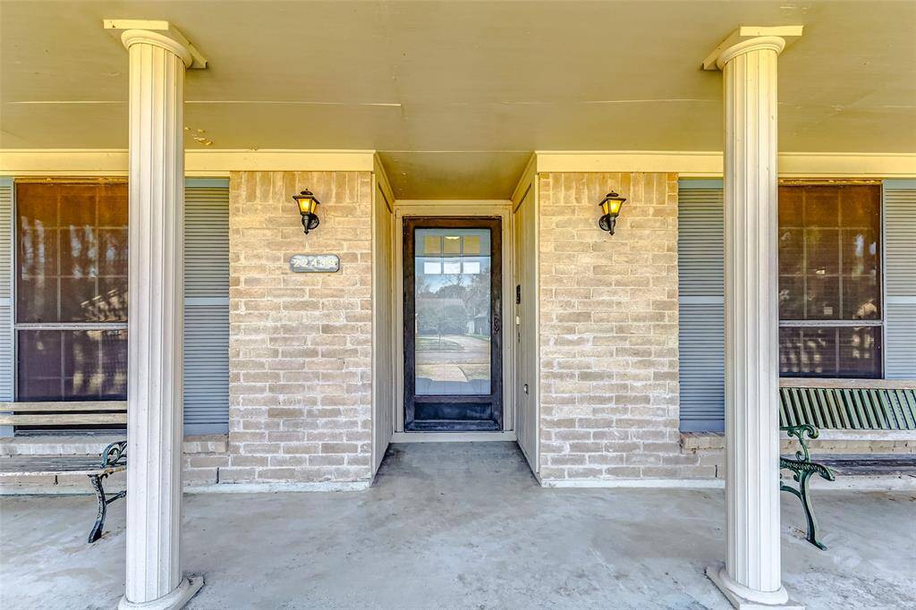 Stroll along the landscaped pathway to your welcoming front porch, spacious enough for a bistro table, chairs, or your favorite patio furniture. The elegant leaded glass front door, paired with a storm door, bathes the entryway in natural light, offering a warm glimpse of the inviting interior. Framing the entrance, two stylish coach lights add a touch of charm and sophistication.