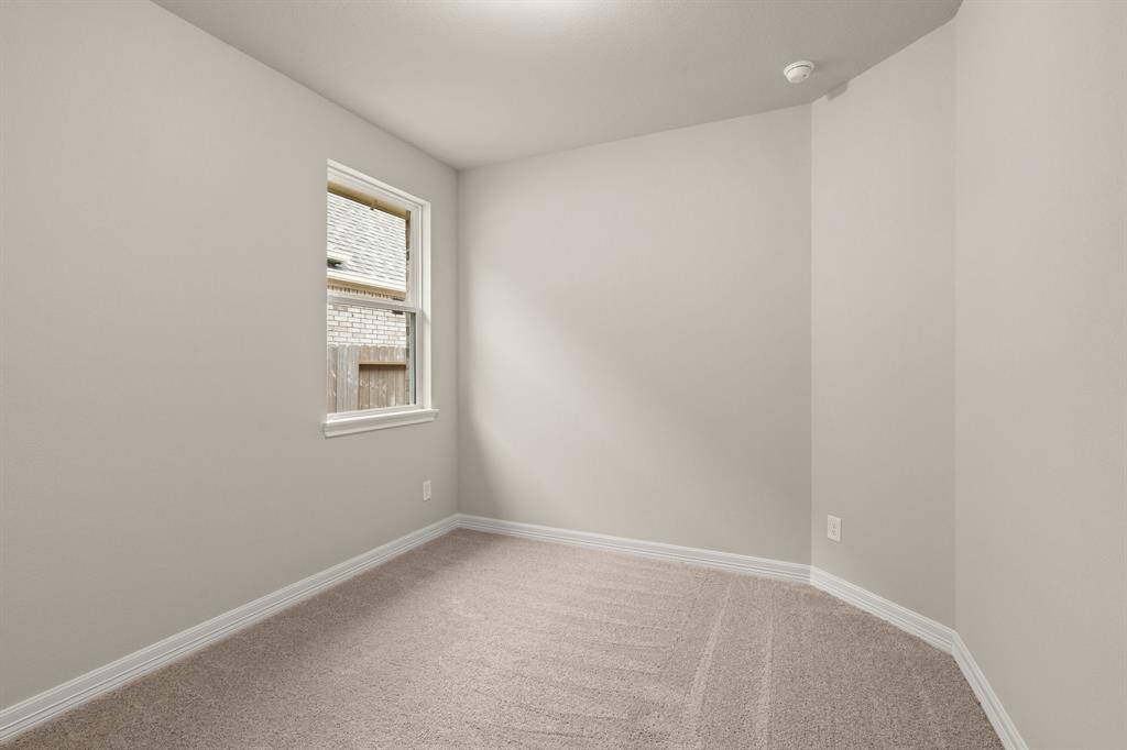 Your secondary bedroom features plush carpet, fresh paint, closet, and a large window that lets in plenty of natural lighting.