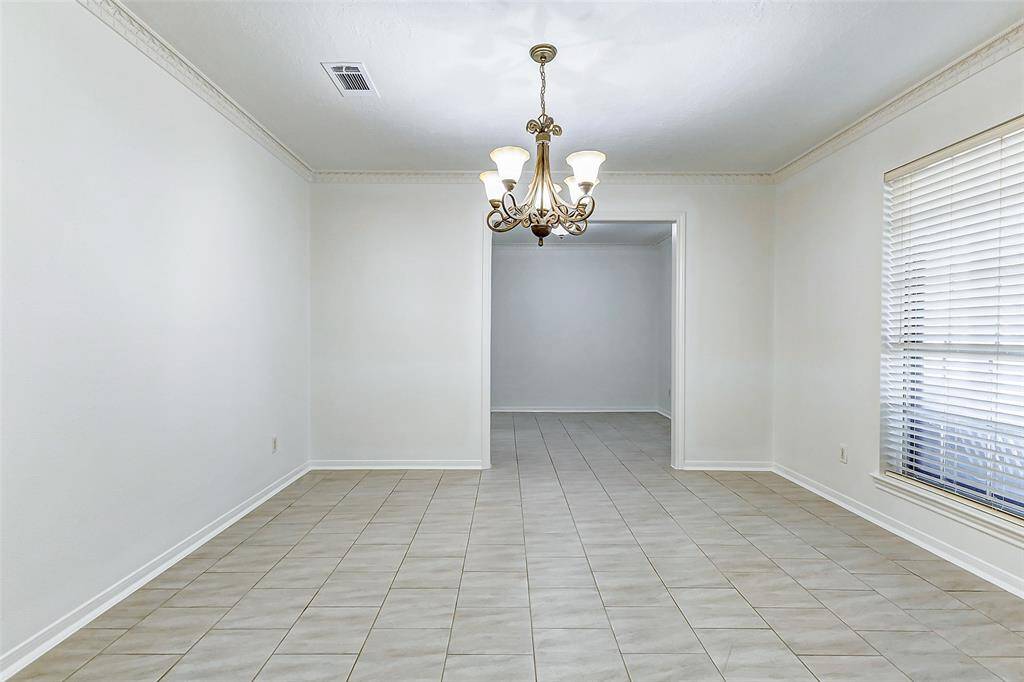 Just off the entryway, the formal dining area offers a charming space to start your day with a cup of coffee, bathed in natural light from a large window overlooking the front yard. Whether enjoying a quiet meal or gathering with loved ones, this inviting space provides a warm and peaceful retreat at the heart of the home.