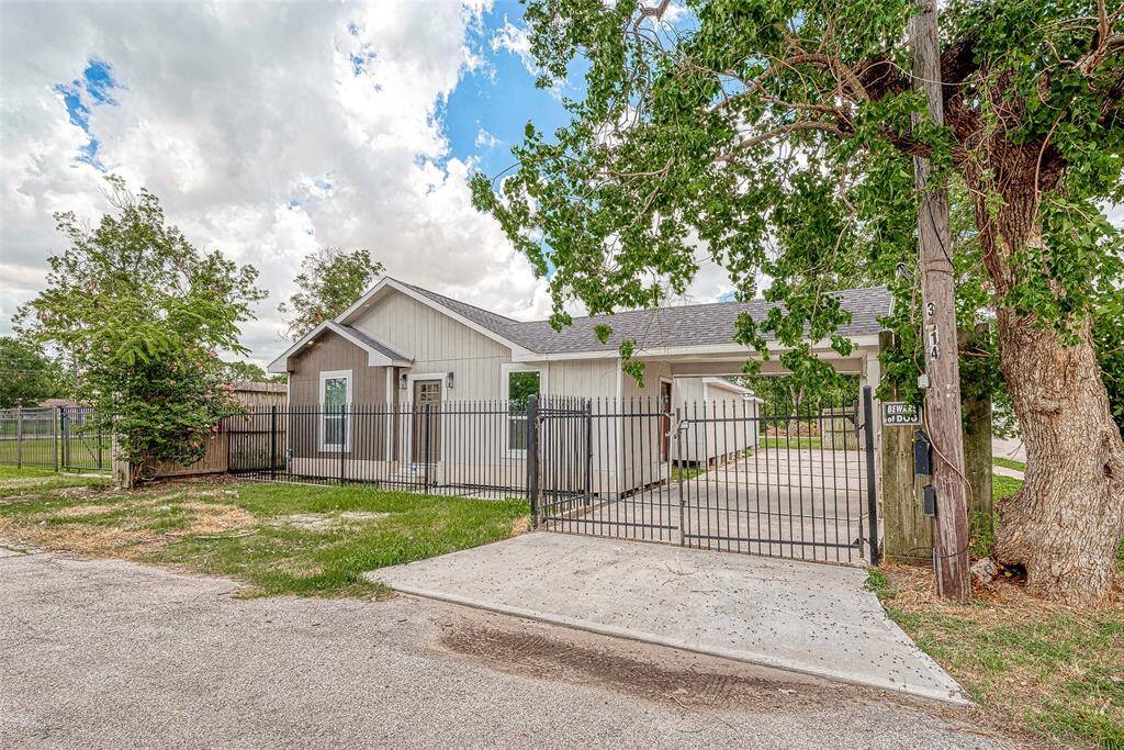 GATED WITH LONG DRIVEWAY ALL THE WAYTO THE BACK OF PROPERTY