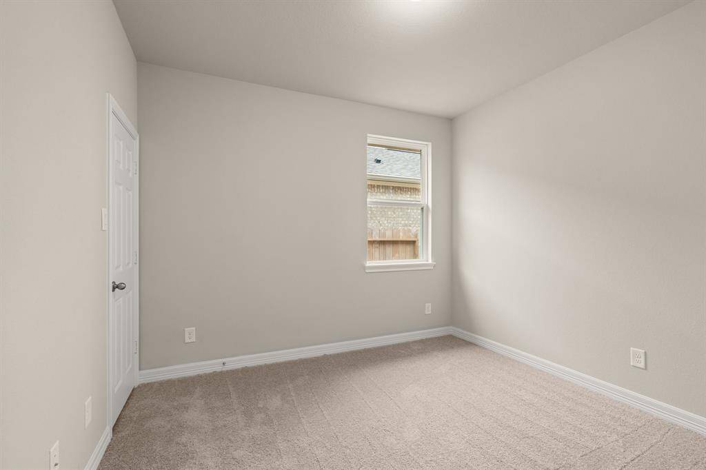 Your secondary bedroom features plush carpet, fresh paint, closet, and a large window that lets in plenty of natural lighting.