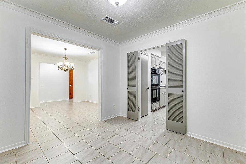 Beyond the dining area, you'll discover a charming den that offers versatility—perfect as a home office, playroom, or flexible living space to suit your needs.
