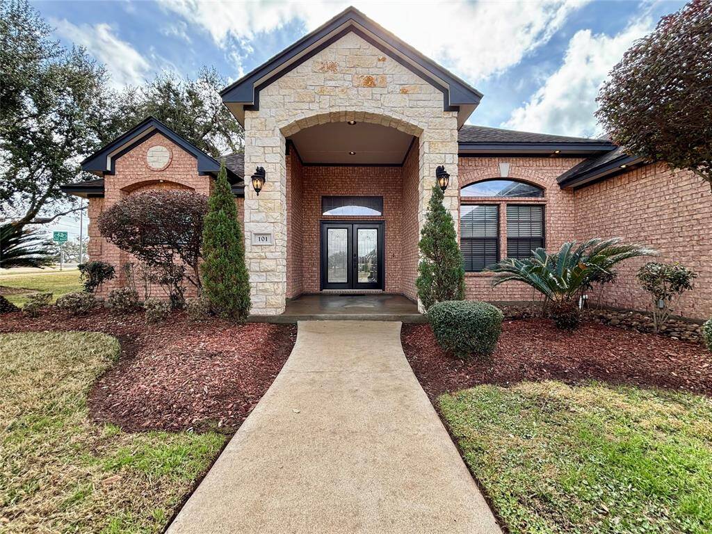 Such a welcoming entryway to greet you everyday with refreshed landscaping, soffit lighting, large covered porch and grand double wood doors with transom window!