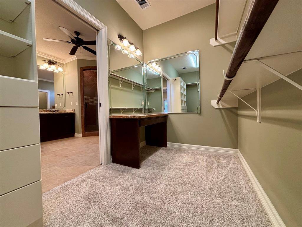 Custom vanity area located inside the master closet is sure to impress!