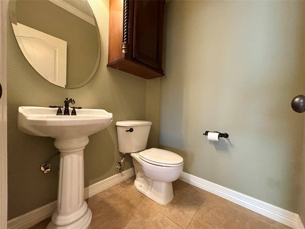 1/2 bath located adjacent to office area, kitchen and utility room make this a very well thought out floor plan feature!