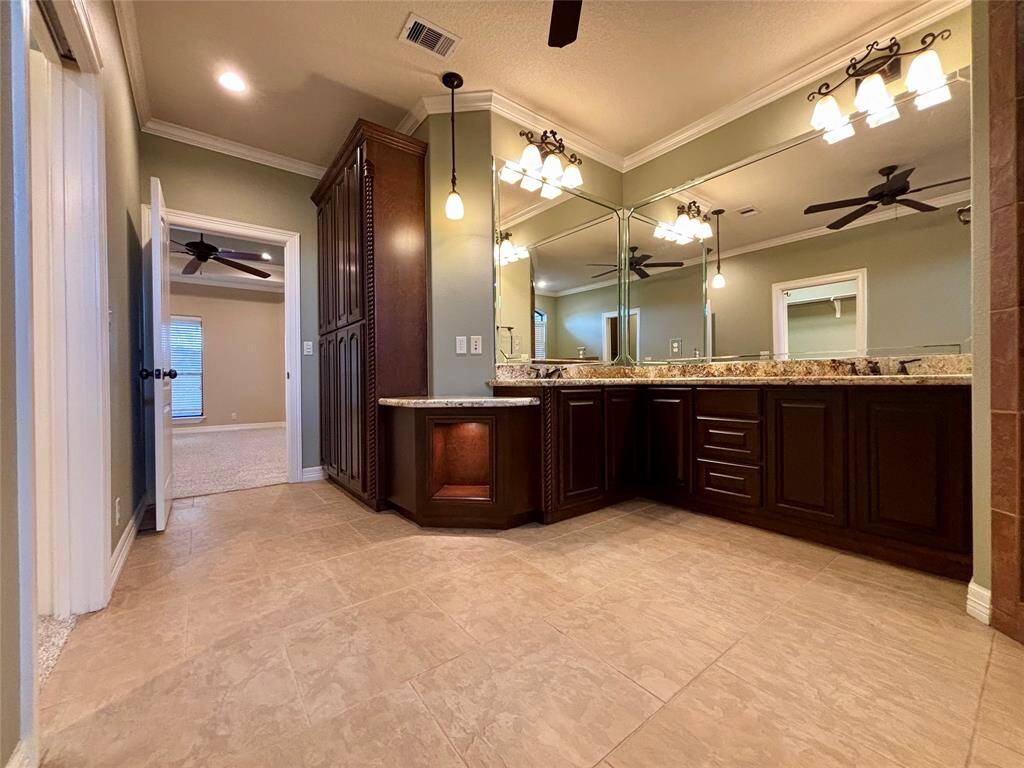 Master spa-like bath fit for royalty! Custom solid wood cabinets with built-in lighting, elegant fixtures and plenty of space!
