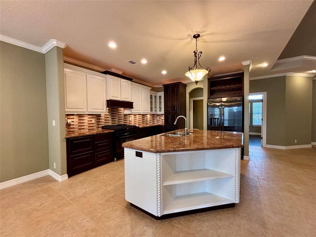 Kitchen is a chef's dream with all the granite counterspace you could imagine, high-end Z-Line custom 6 burner gas range and oven, custom tile back splash, under cabinet lighting, up-lighting and custom built kitchen drawers with metal sides and laminated drawers!