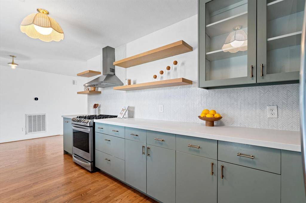 Renovated in 2019, kitchen features modern finishes, custom soft-close cabinetry, and LG and GE appliances.
