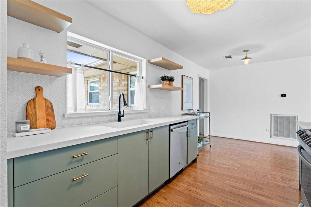Renovated in 2019, the kitchen features modern finishes, custom soft-close cabinetry, and LG and GE appliances.