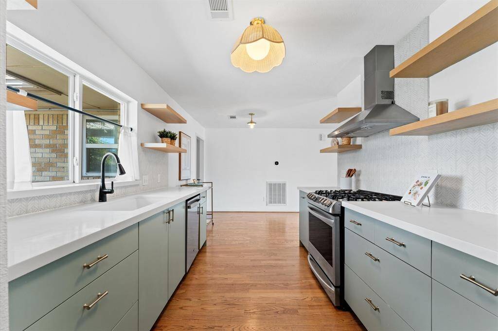 Renovated in 2019, the kitchen features modern finishes, custom soft-close cabinetry, and LG and GE appliances.