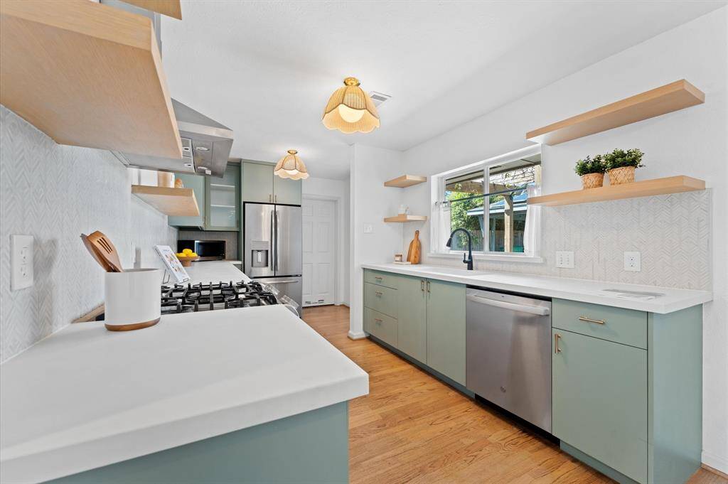 Renovated in 2019, the kitchen features modern finishes, custom soft-close cabinetry, and LG and GE appliances.