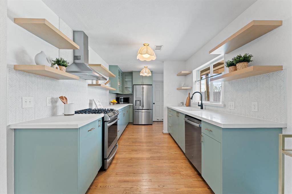 Renovated in 2019, the kitchen features modern finishes, custom soft-close cabinetry, and LG and GE appliances.
