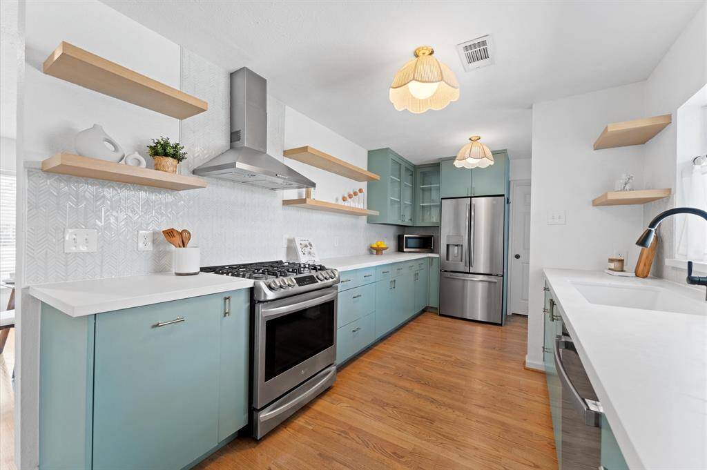Renovated in 2019, the kitchen features modern finishes, custom soft-close cabinetry, and LG and GE appliances.