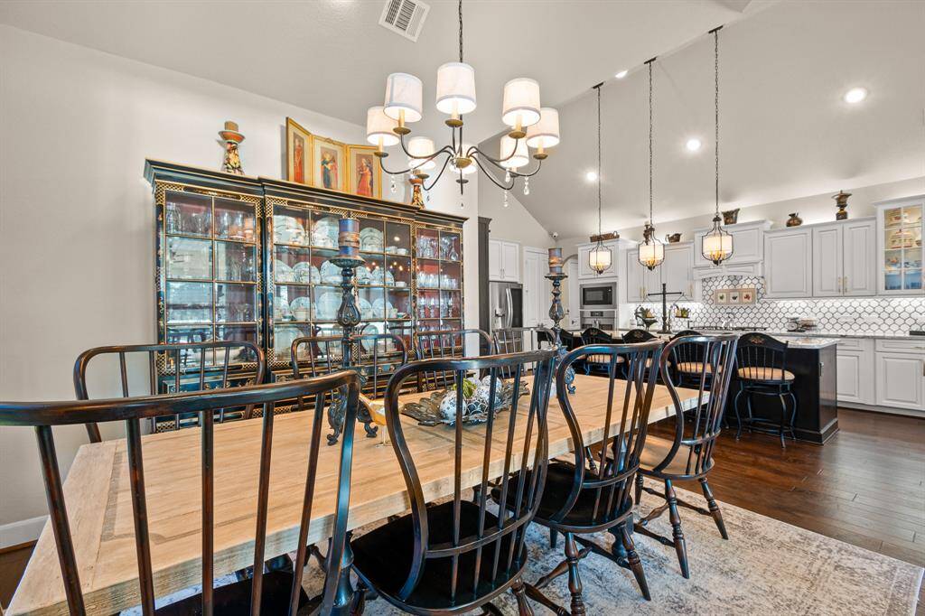 Elegant Dining Room enhanced by high ceilings with chic lighting fixtures. You can host a large group of friends and can even accomodate a large furniture such as a China Cabinet.  The windows boast of a gorgeous view of the Community Lake while your dining.