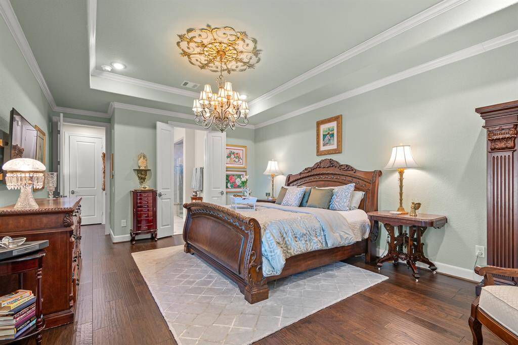 This luxurious Primary Suite features elegant decor and abundant natural light for a cozy ambiance. Highlighted by trayed ceiling that blends seamlessly with the room's sophisticated charm.