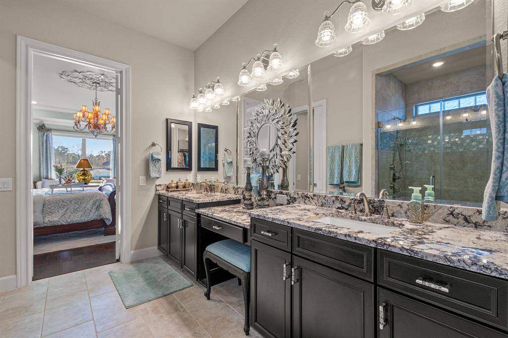 Primary En-Suite bathroom featuring a double sinks and seated vanity with granite countertops, modern lighting fixtures, and ample cabinet space. Pleanty of space to move about!