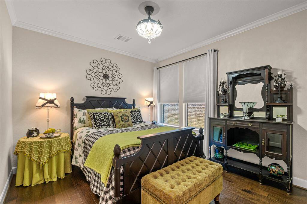 Downstairs secondary Bedroom features Fandalier Ceiling Fan where the blades retract when not in use.   With abundant natural light, highlighting soft, neutral walls and walk in closet.