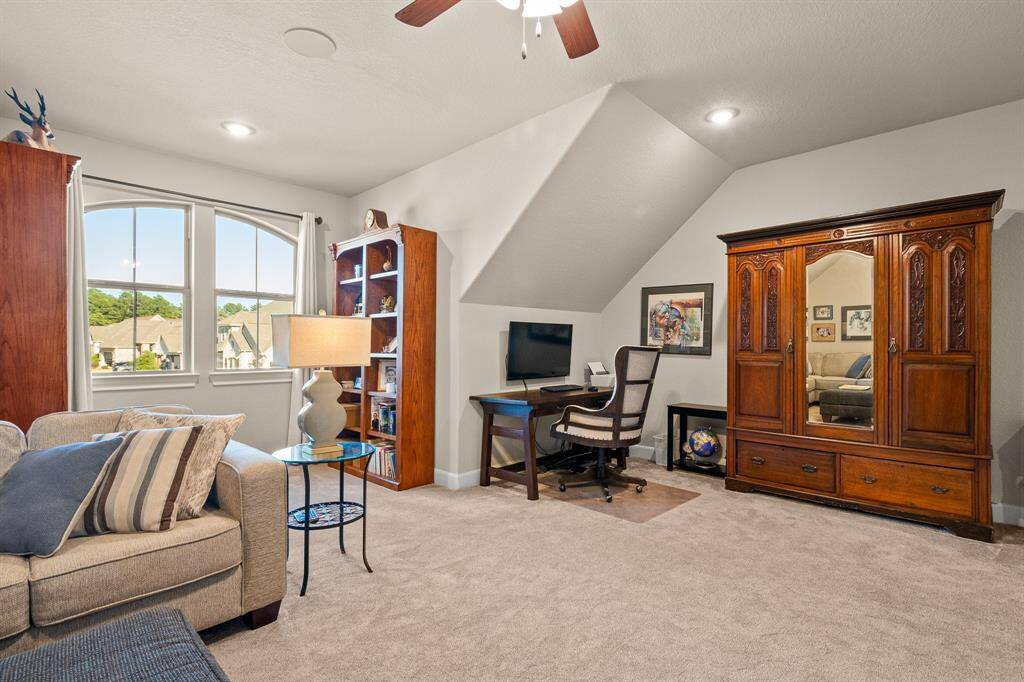 This inviting Gameroom/Living Room upstairs boasts of a cozy seating area, that could be ideal for a home office or serene retreat.