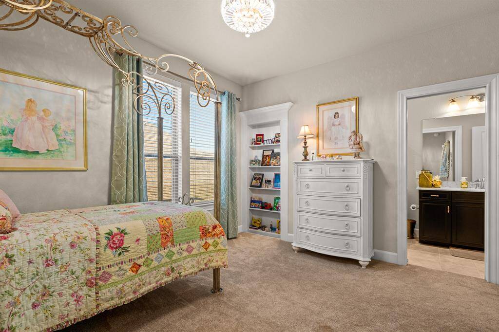 Discover the 3rd Bedroom with enough space for twin beds, a dresser, built-in shelves, and an attached bathroom, offering warmth and comfort.  Direct access to the Bathroom.  This bedroom also has a Fandalier!