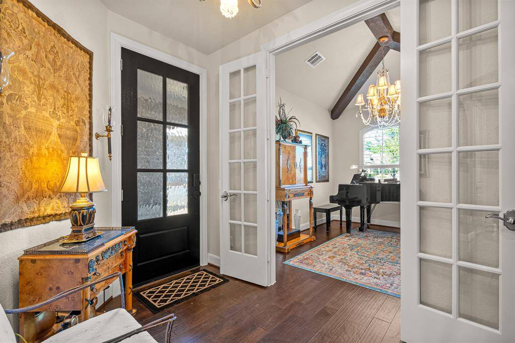 This welcoming foyer features Glass French Doors leading to the stylish Home Office/Study, seamlessly blending classic and modern touches.
