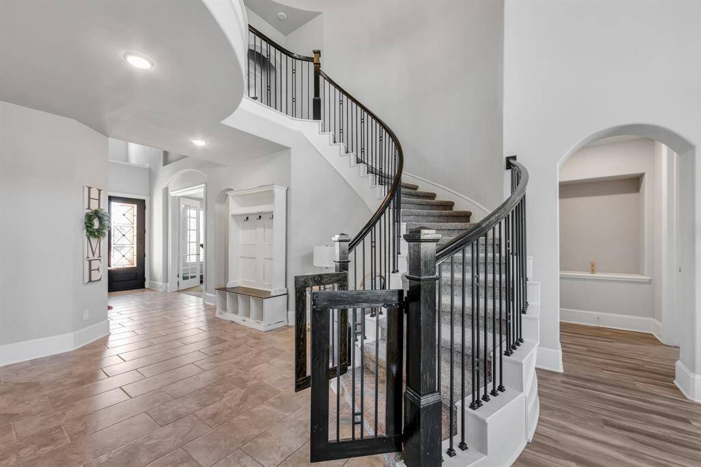 Gorgeous spiral staircase with wrought iron spindles.