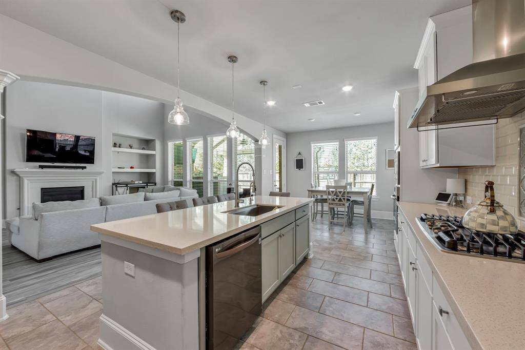 Chef's kitchen with 5 burner cooktop, farm sink, island seating and pendant lighting are just some of the features in the open concept kitchen.